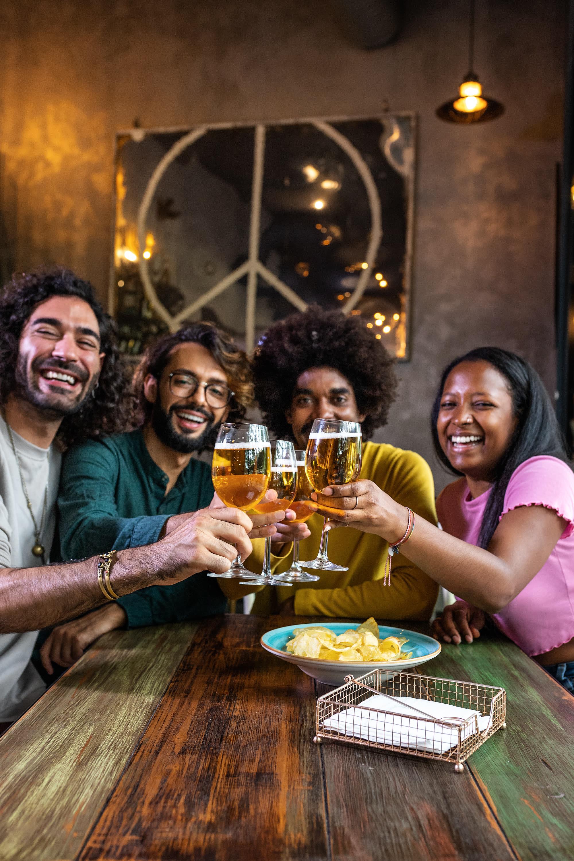 Friends toasting at a bar